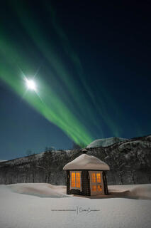 Norwegian Warming Hut Under the Northern Lights